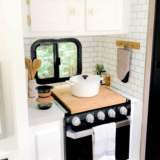 Finished rental kitchen with a decorative backsplash above the countertop