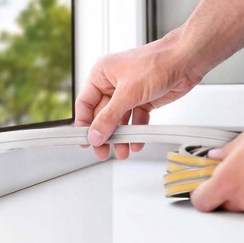Weatherstripping being installed along a window frame to reduce air leaks